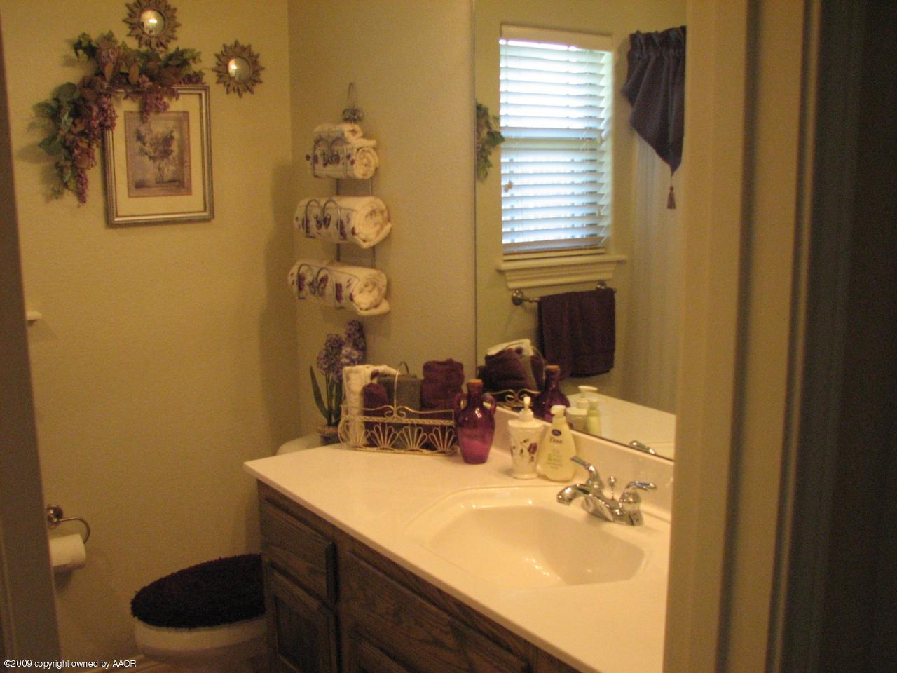 6602 Slater Circle Amarillo, TX 79110 - Photo 15 of 25 a bathroom with a sink and a mirror