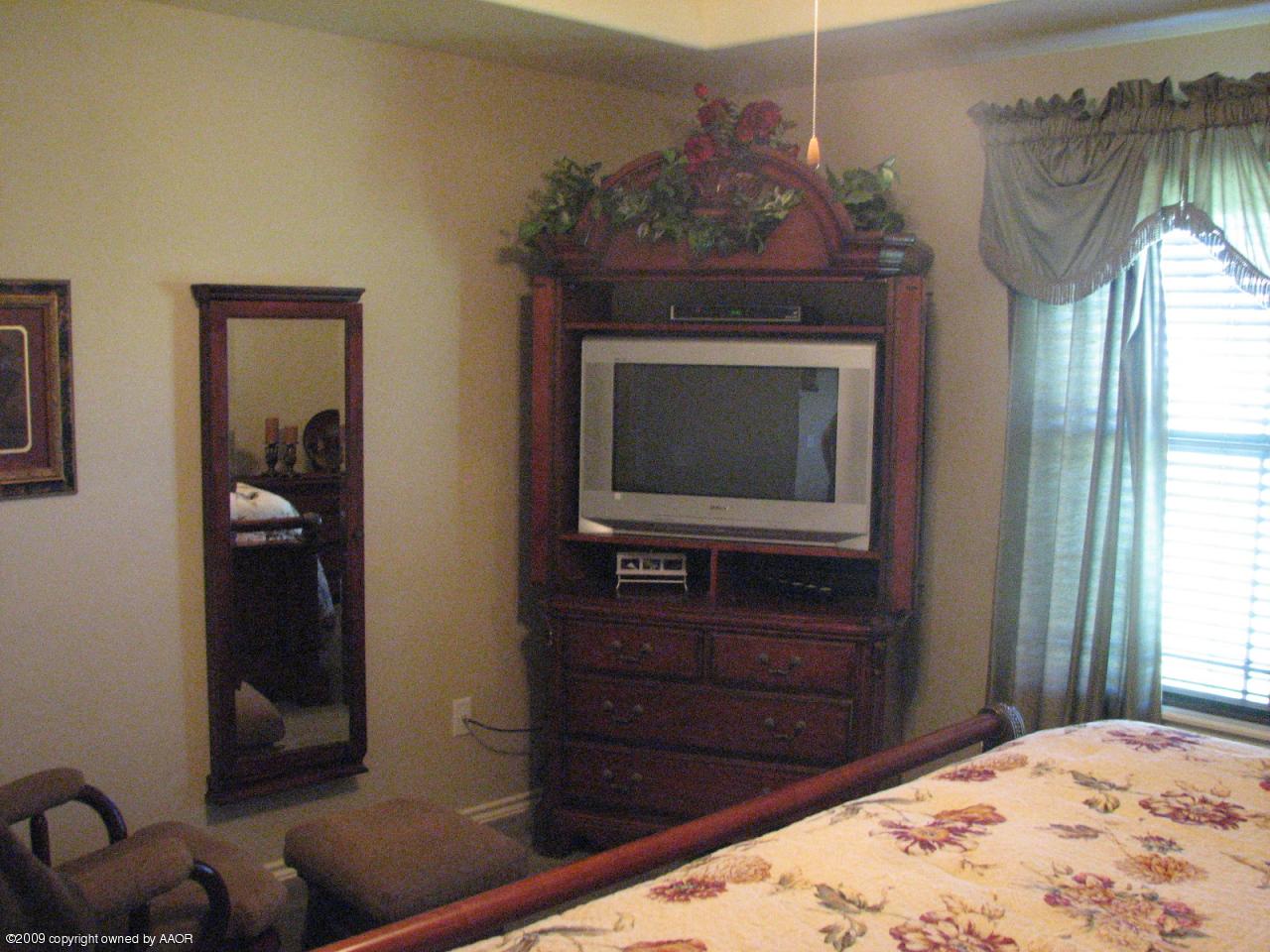 6602 Slater Circle Amarillo, TX 79110 - Photo 7 of 25 a bedroom with a bed and a television