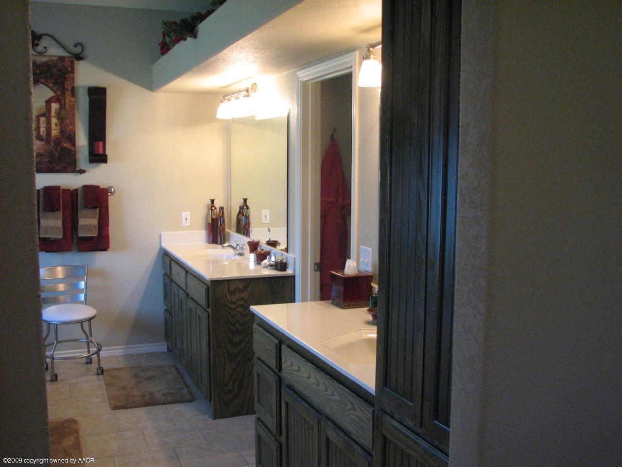 6602 Slater Circle Amarillo, TX 79110 - Photo 8 of 25 a bathroom with a sink and a mirror