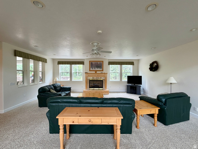 1133 Paris Canyon Road Paris, ID 83261 - Photo 11 of 75 Spacious carpeted living area featuring a fireplace with a wood mantel, multiple windows, recessed lighting, and a ceiling fan