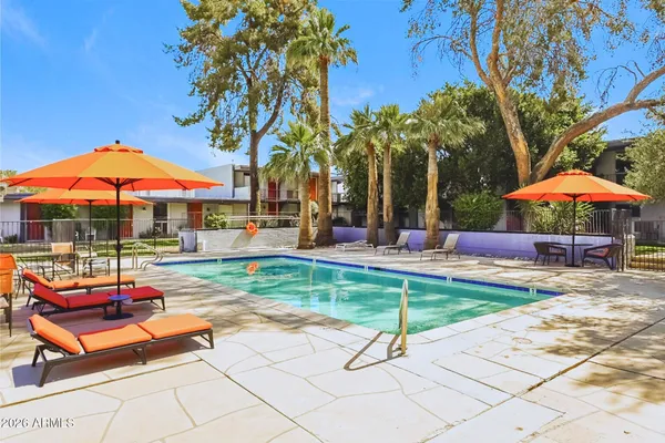 a view of a backyard with a patio and fire pit