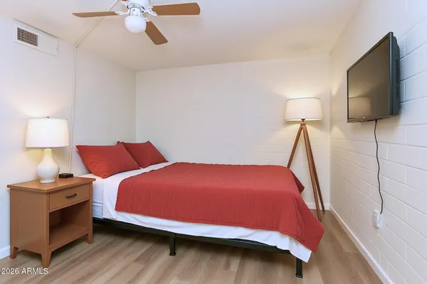 a bedroom with a bed and a potted plant