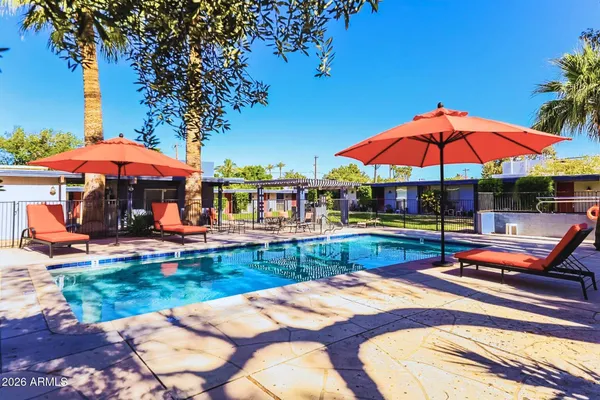 a bedroom with a bed and a potted plant