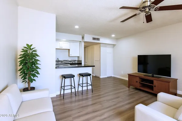 a living room with furniture and a ceiling fan