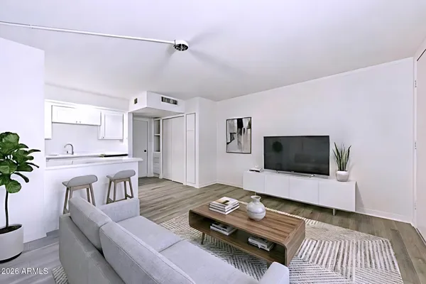 a living room with furniture and a flat screen tv