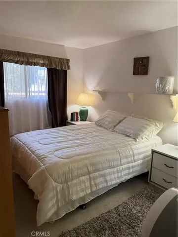 a bedroom with a bed and a window