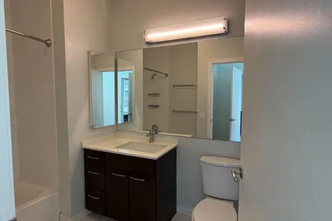 a bathroom with a sink toilet and mirror