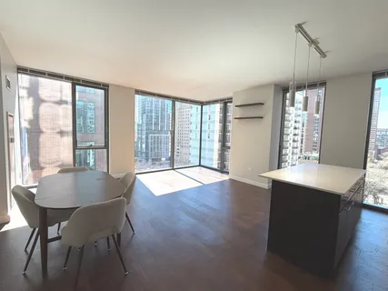a dining room with furniture and wooden floor