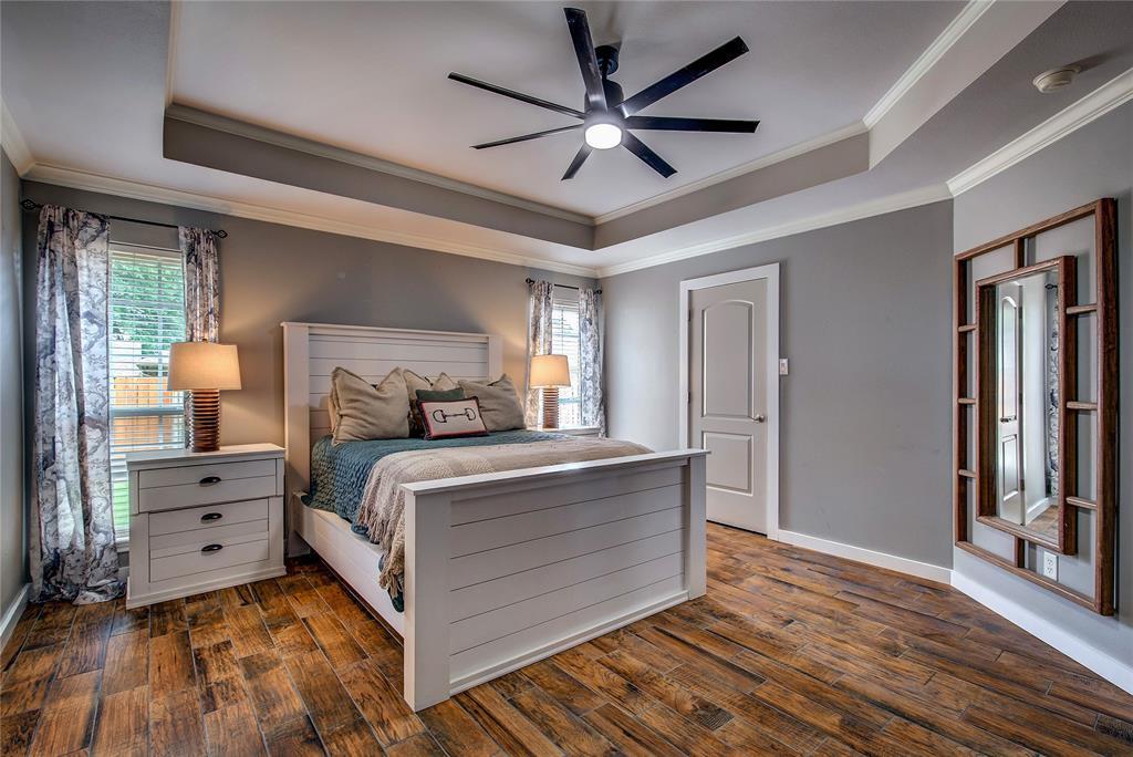 2027 Park Springs Road Sulphur Springs, TX 75482 - Photo 18 of 39 a bed room with a bed and a ceiling fan