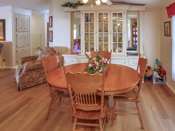 a view of a dining room with furniture and wooden floor