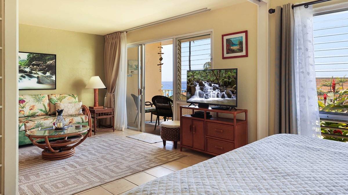 1763 Pe'e Road, Unit 103 Koloa, HI 96756 - Photo 7 of 23 a bed room with a bed and a couch