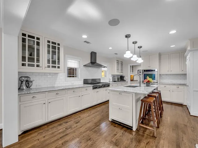a kitchen with cabinets a sink and appliances in it