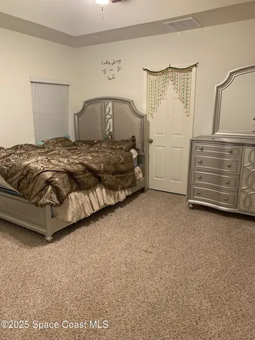 a bedroom with a bed and cabinets