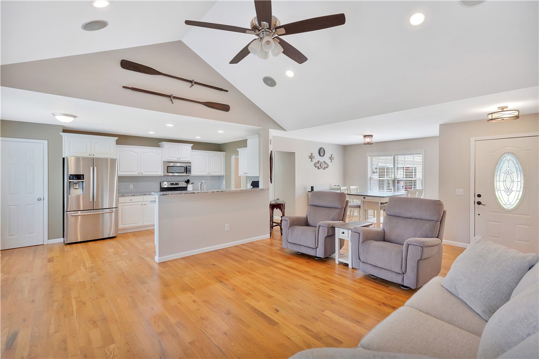 131 Morgan Road West Union, SC 29696 - Photo 6 of 39 An open-concept living space features warm hardwood floors and a bright kitchen.