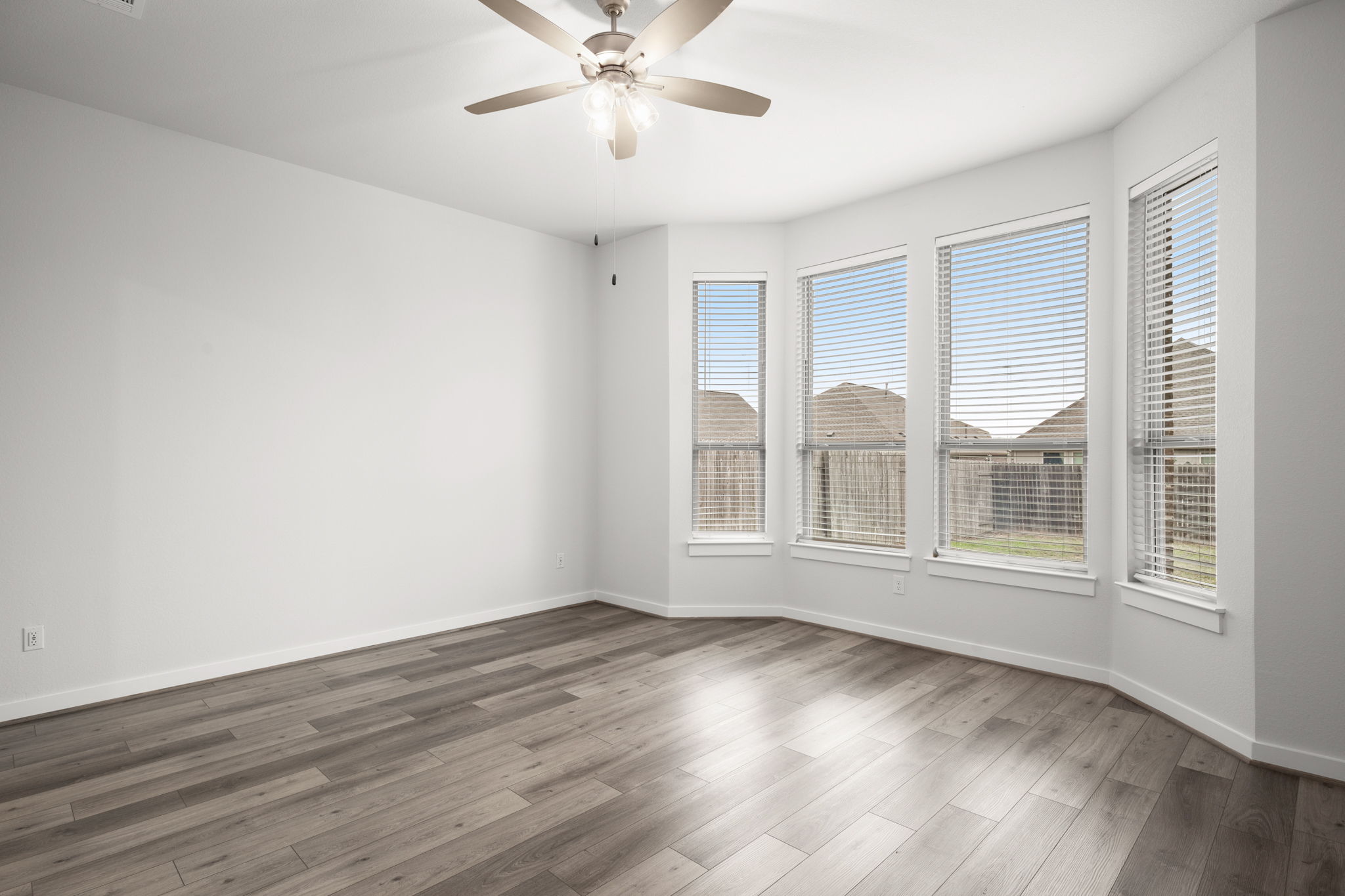 841 Spinnaker Loop Kyle, TX 78640 - Photo 24 of 40 Unfurnished room with wood finished floors and ceiling fan