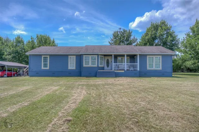 a front view of a house with yard