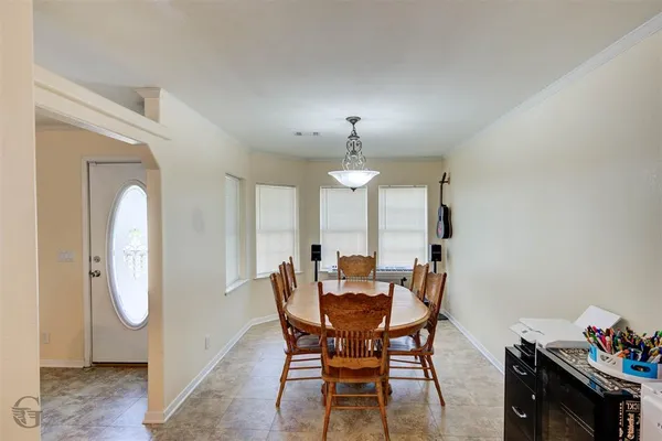 a view of a dining room with furniture and chandelier