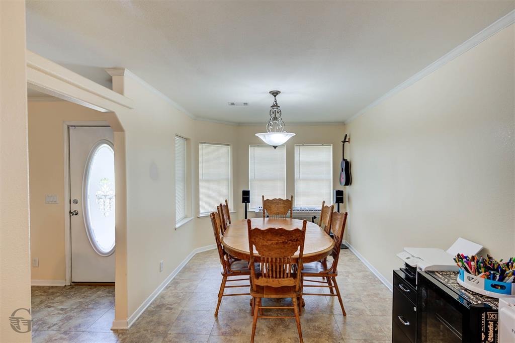4807 Greenwood Heights Road Greenwood, LA 71033 - Photo 11 of 21 a view of a dining room with furniture and chandelier