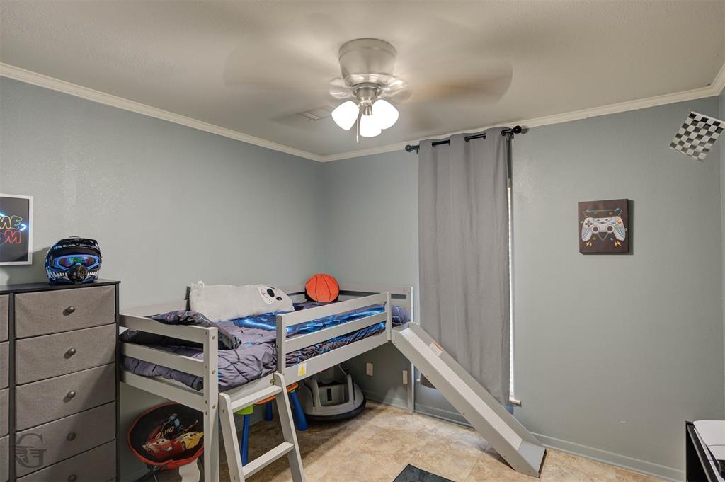 4807 Greenwood Heights Road Greenwood, LA 71033 - Photo 13 of 21 a bed room with a bed and a chandelier