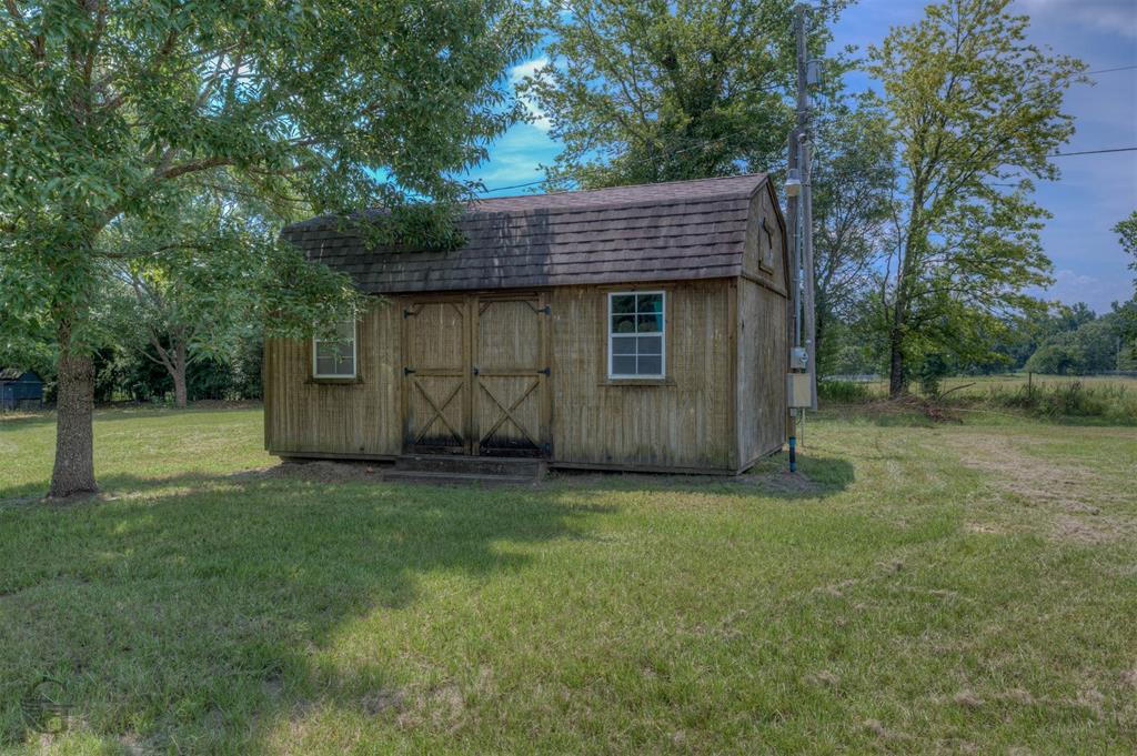 4807 Greenwood Heights Road Greenwood, LA 71033 - Photo 18 of 21 a view of a house with a yard