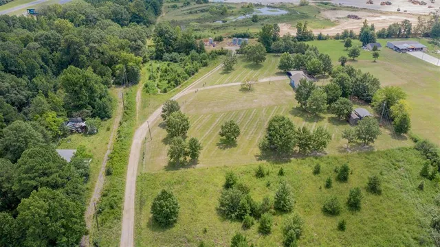 an aerial view of a house with outdoor space and lake view