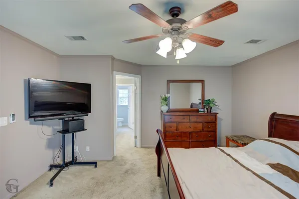 a bedroom with furniture and a flat screen tv