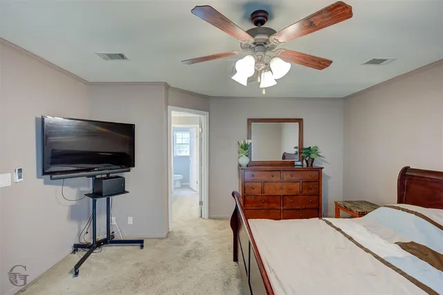 a bedroom with furniture and a flat screen tv