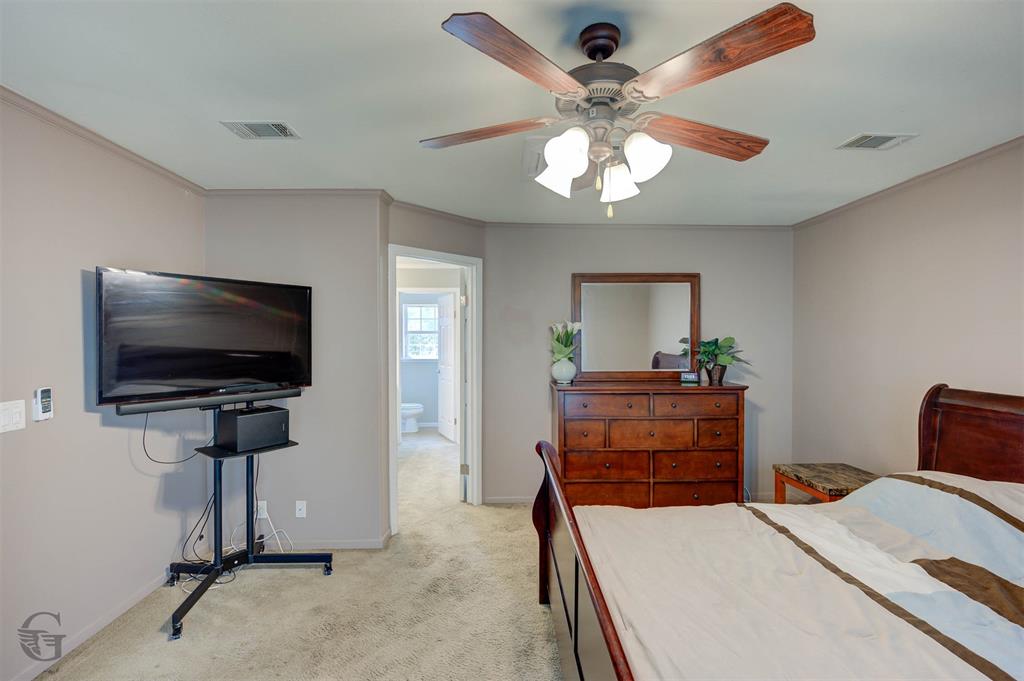 4807 Greenwood Heights Road Greenwood, LA 71033 - Photo 4 of 21 a bedroom with furniture and a flat screen tv