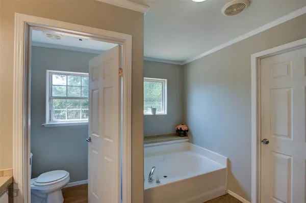 a bathroom with a tub and sink