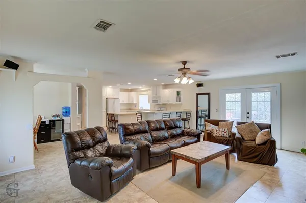 a living room with furniture ceiling fan and a rug