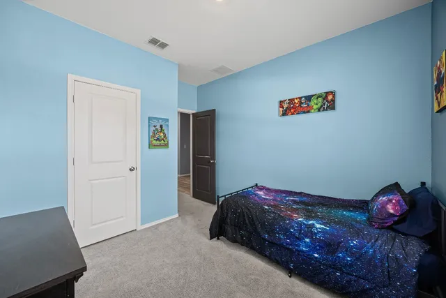 a bedroom with a bed and a dresser