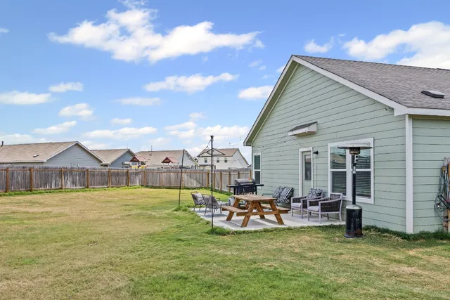 a view of a house with patio and garden