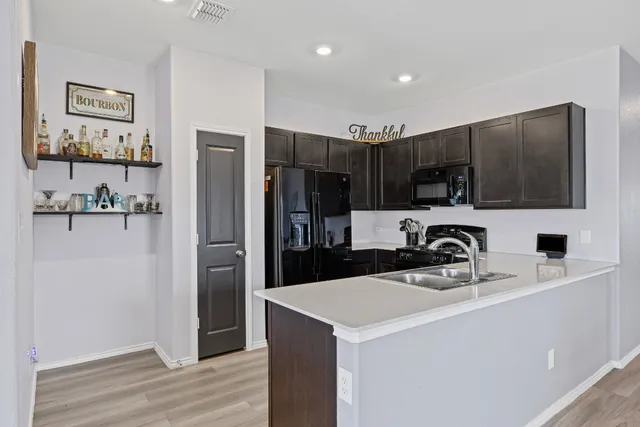 a kitchen with stainless steel appliances a refrigerator sink and microwave