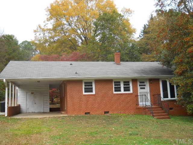 4104 Campbell Road Raleigh, NC 27606 - Photo 1 of 6 Front of home showing carport and storage room.
