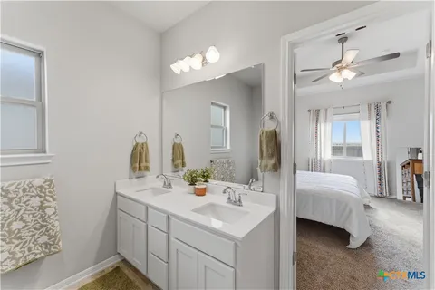 a bathroom with a sink vanity and a mirror