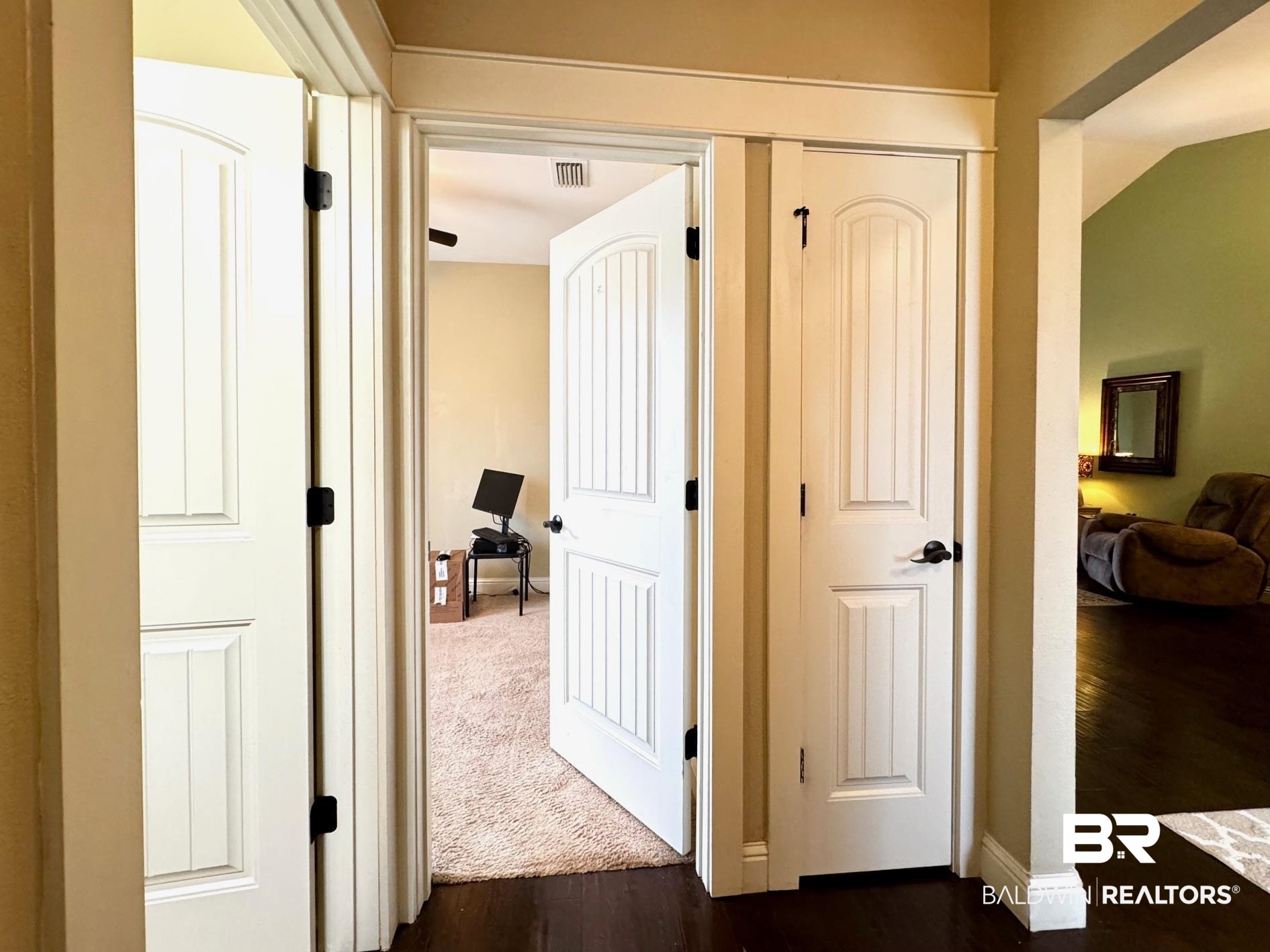 1030 Crown Walk Drive Foley, AL 36535 - Photo 24 of 40 Hall with visible vents, baseboards, and dark wood-style flooring