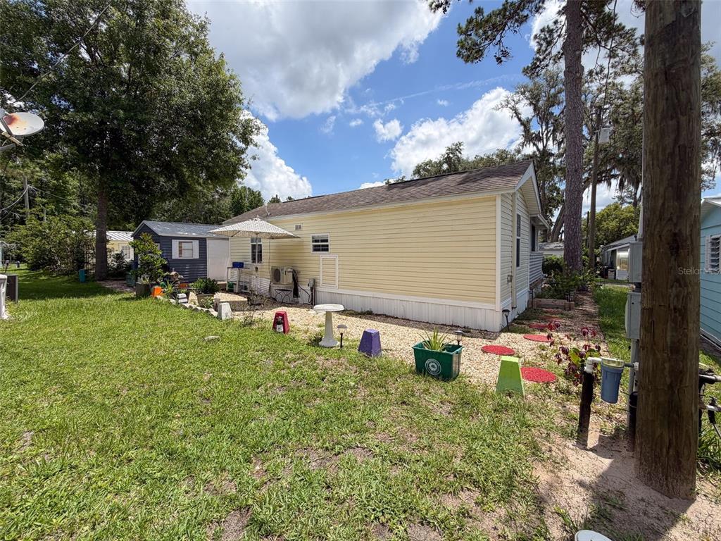 2092 Culbreath Road, Unit A42 Brooksville, FL 34602 - Photo 52 of 70 a backyard of a house with table and chairs