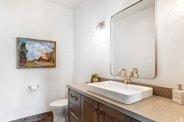 1282 Chimney Rock Road, Unit 344 Heber City, UT 84032 - Photo 22 of 55 Bathroom vanity featuring a rectangular vessel sink, brushed gold faucet, and a large wall-mounted mirror