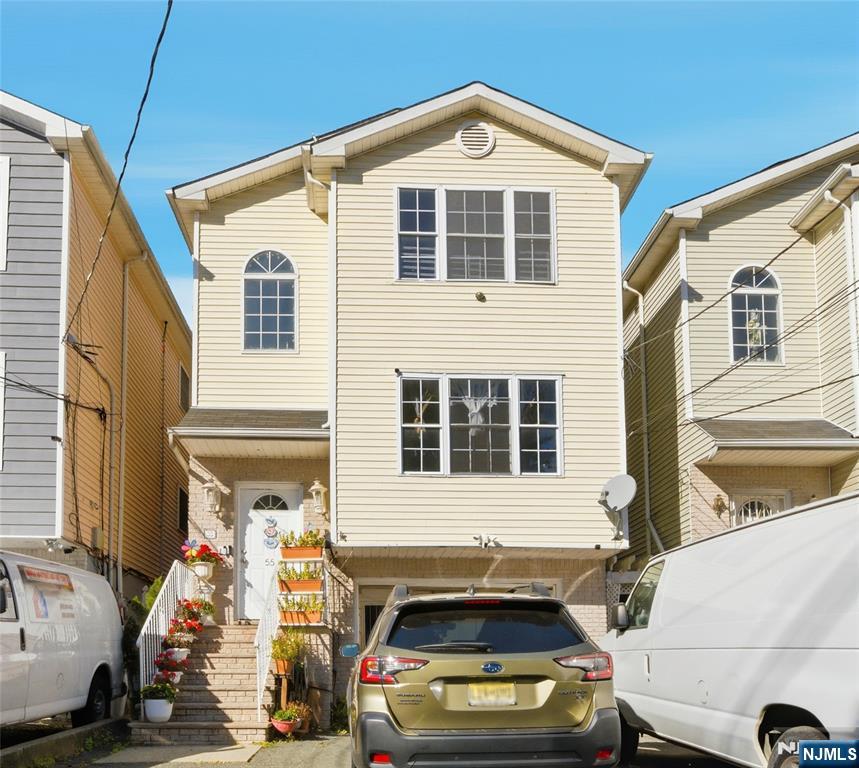 55 Lincoln Avenue, Unit 2 Newark, NJ 07104 - Photo 1 of 21 a front view of a house with a large window
