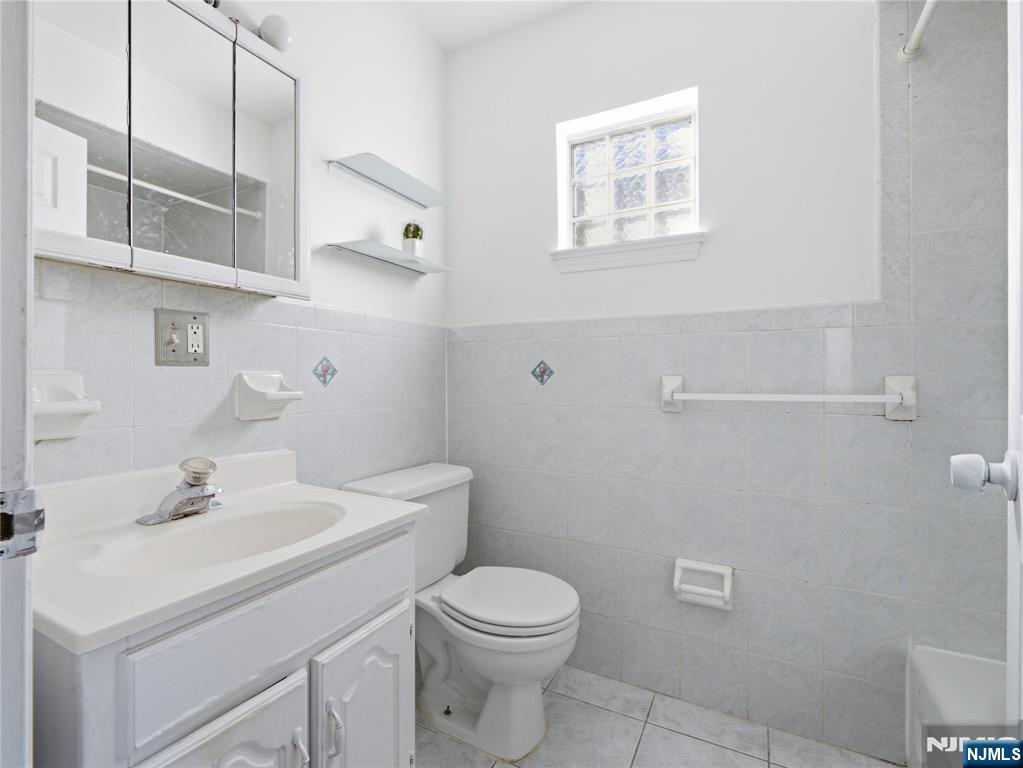 55 Lincoln Avenue, Unit 2 Newark, NJ 07104 - Photo 21 of 21 a bathroom with a sink a toilet and shower