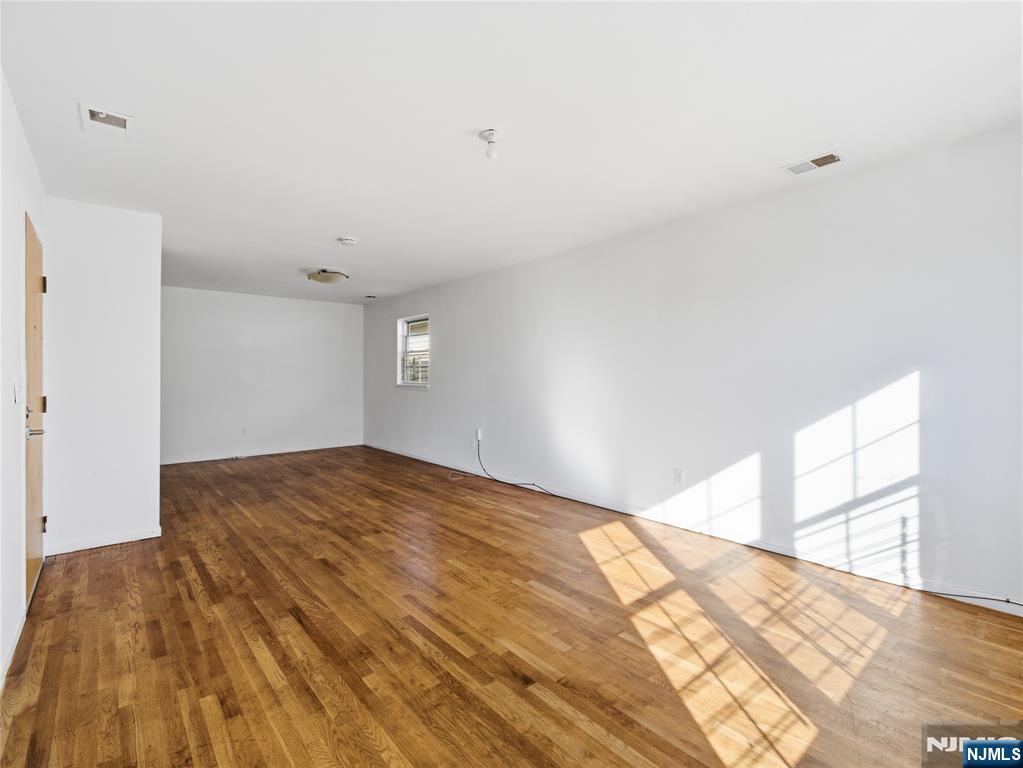 55 Lincoln Avenue, Unit 2 Newark, NJ 07104 - Photo 4 of 21 a view of empty room with wooden floor