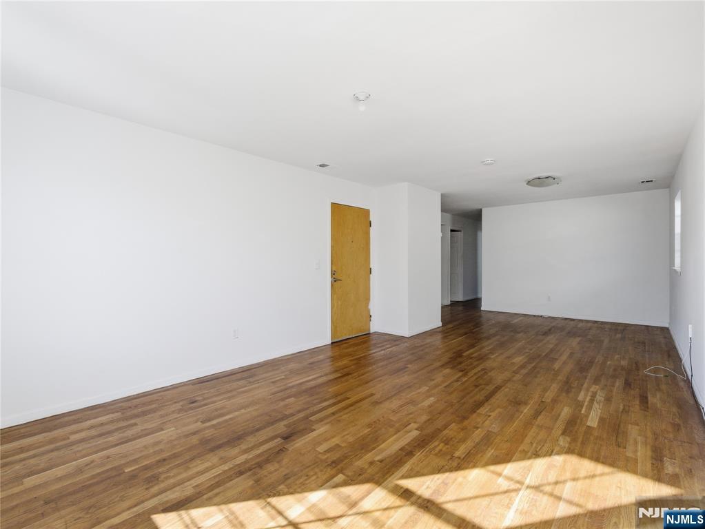 55 Lincoln Avenue, Unit 2 Newark, NJ 07104 - Photo 5 of 21 a view of empty room with wooden floor