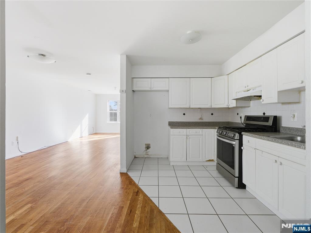 55 Lincoln Avenue, Unit 2 Newark, NJ 07104 - Photo 10 of 21 a kitchen with a stove a sink and a refrigerator