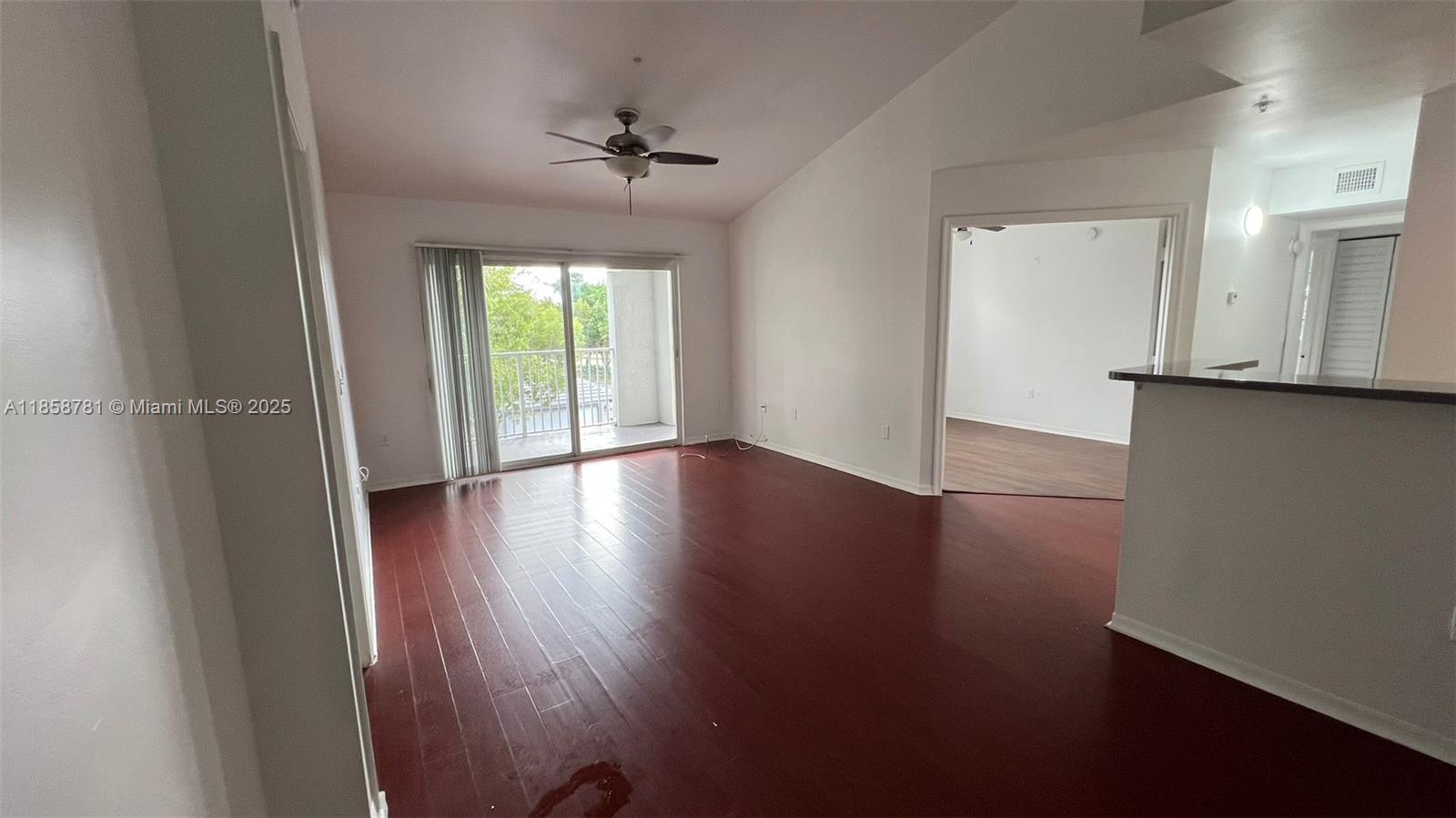 711 Southwest 111th Way, Unit 3017 Pembroke Pines, FL 33025 - Photo 4 of 20 a view of empty room with wooden floor and fan
