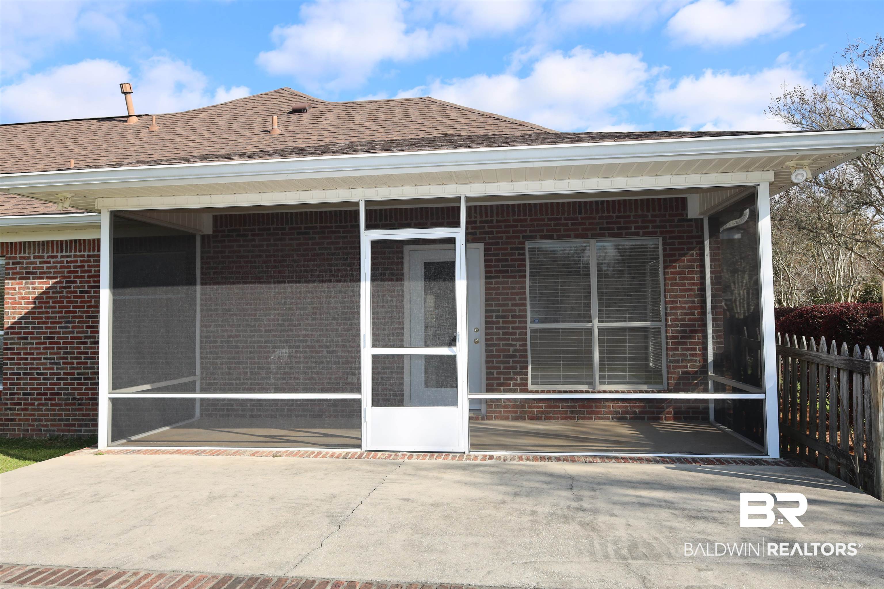 111 Destrehan Road Fairhope, AL 36532 - Photo 22 of 29 Back of property with brick siding, a shingled roof, and a sunroom