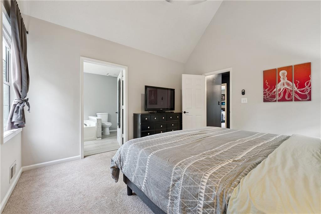 8020 Estee Drive Cumming, GA 30028 - Photo 18 of 41 a spacious bedroom with a bed and a flat screen tv