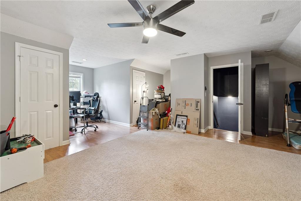 8020 Estee Drive Cumming, GA 30028 - Photo 28 of 41 a view of a livingroom with furniture and a ceiling fan