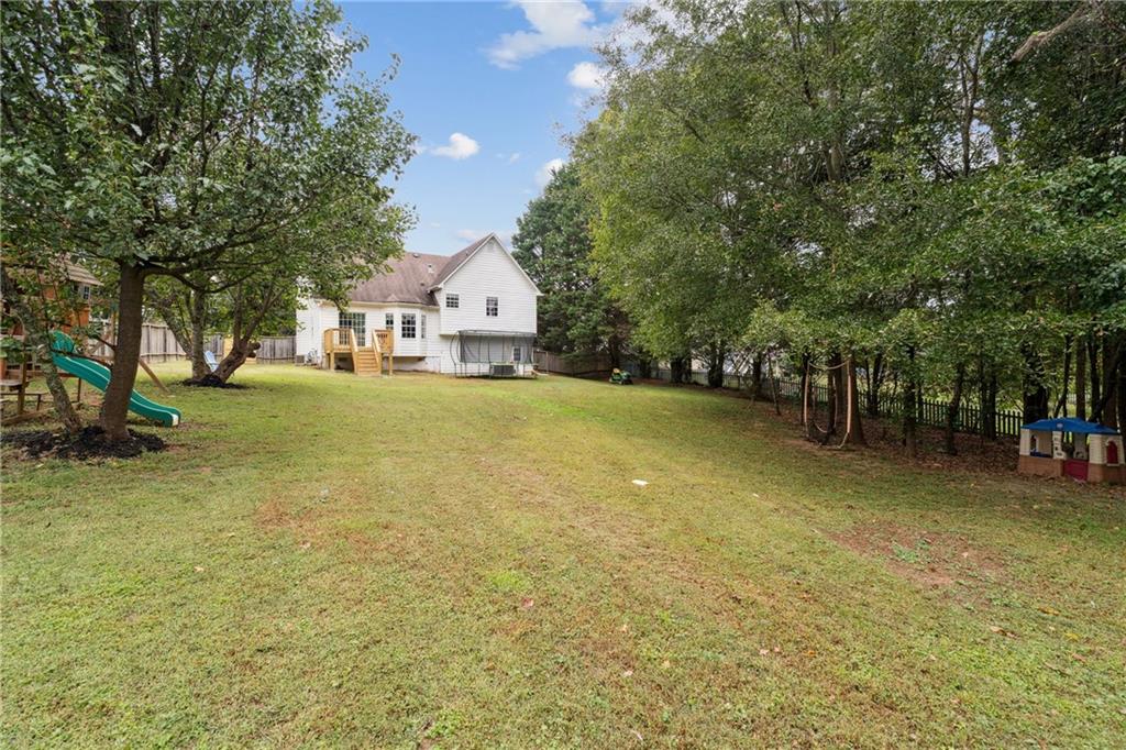 8020 Estee Drive Cumming, GA 30028 - Photo 33 of 41 a view of a house with a yard and tree s