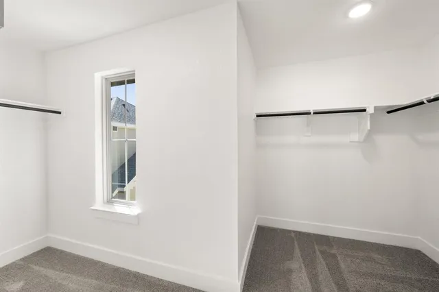 a view of a small space with wooden floor and a window