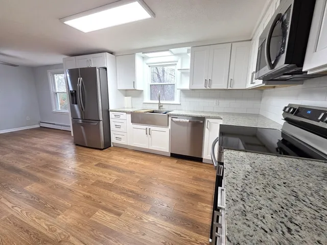 a kitchen with refrigerator and cabinets
